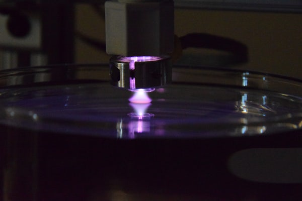 A digital photograph of a low-temperature He plasma jet in contact with an aqueous solution. (Thimsen lab)