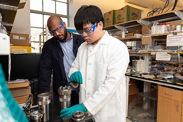 Marcus Foston (left) and collaborators are exploring how to use lignin, a common waste product of paper pulping, as a source of renewable alteratives to petroleum-derived chemicals. (Photo: Jerry Naunheim)