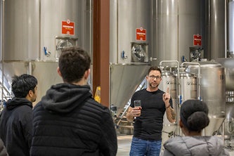 Kurt Driesner gives students a tour of Urban Chestnut brewery and its fermenters. (Joe Angeles)
