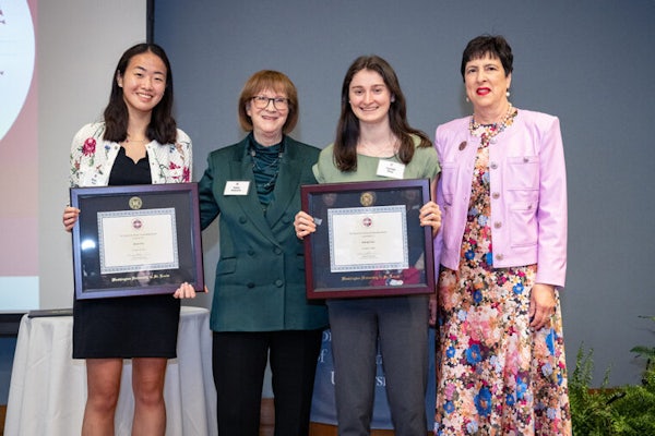 Kathy Fulstone (second from left), scholarship committee chair, and Angie Bernardi (right), president of the Women’s Society, present the Switzer Leadership Award to recipients Shelei Pan (left) and Haleigh Pine. (Photo: Carol Green/Washington University)