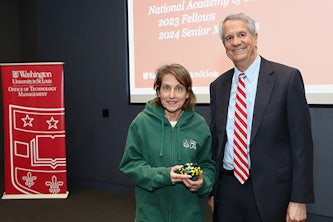 Lori Setton, PhD with Mark Lowe, MD. Setton accepted the National Academy of Inventors Senior Member award on behalf of Hong Chen, PhD. (Photo by Katrina Shaw)
