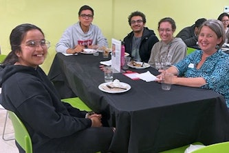  Lisa Gillis-Davis, far right, joins students at the first-generation student dinner held in November in celebration of First-Gen Week. Gillis-Davis is leading the new student support team within Undergraduate Student Services.