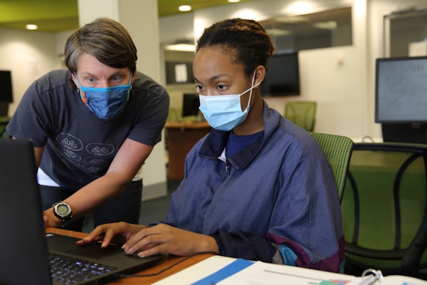 Marion Neumann, left, works with a student during the 2021 AI for St. Louis summer camp. Submitted photo